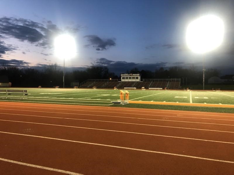 football stadium with lights on